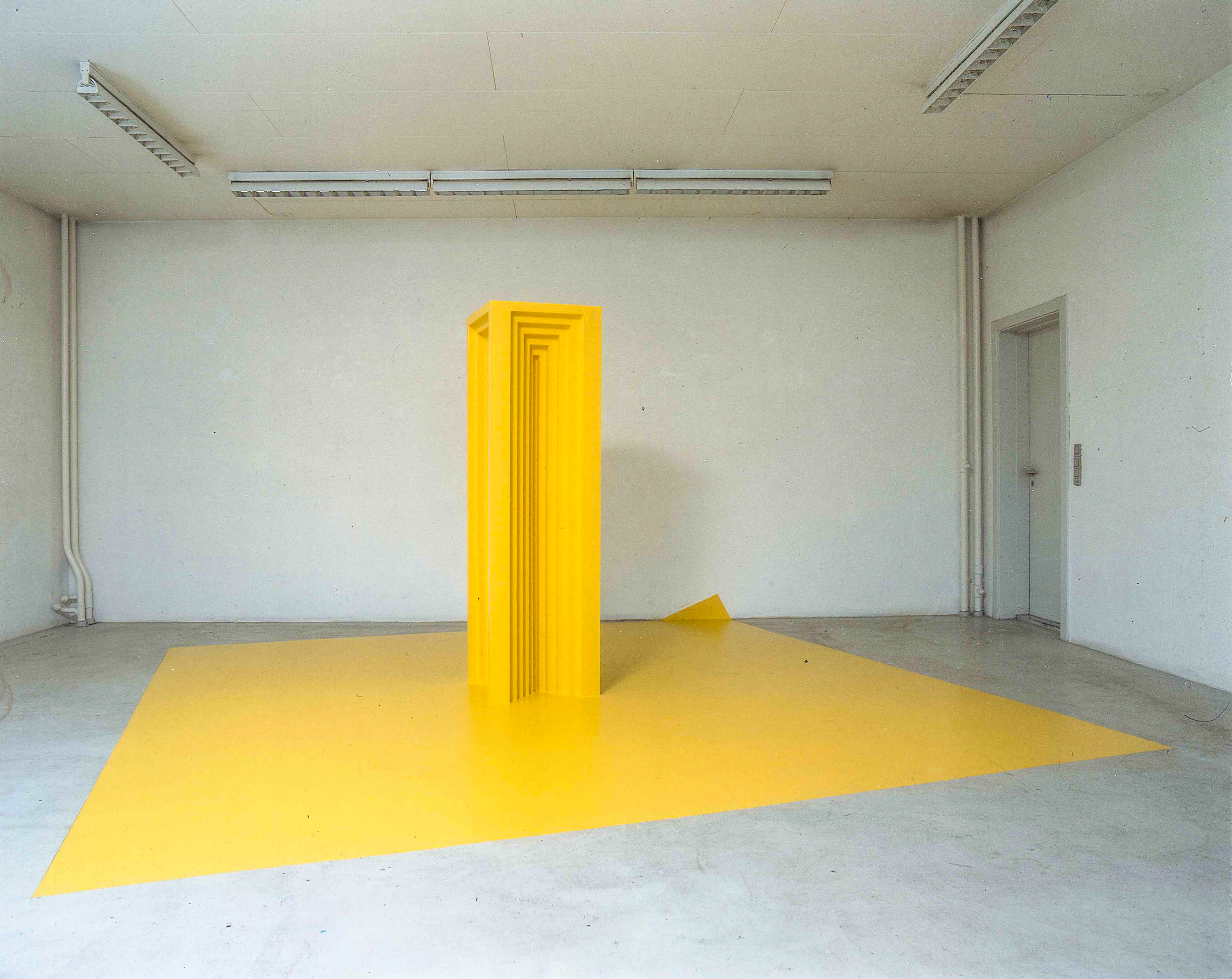 Sculptures at Gallery 2112 capturing movement imprints—plaster forms with centrifugal traces, a yellow wood piece with layered marks, and textile-wrapped structures. 2